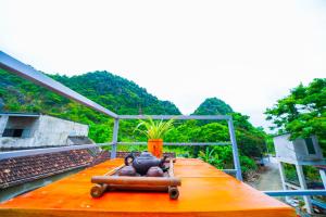 a person laying on a table with a vase on it at Phong Nha Magic Fingers Homestay and Spa in Phong Nha