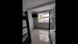 a room with a bunk bed and a window at Bm-15 room near the sea with air conditioning and WIFI in Cartagena de Indias