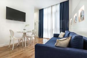 a living room with a blue couch and a table at Central apartment by Picasso Museum by REMS in Málaga