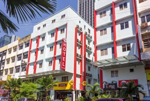 a white building with a red stripe on it at My Hotel @ KL Sentral in Kuala Lumpur