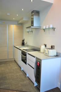 a kitchen with a counter with a toaster and a appliance at Penthouse in Old Street in London