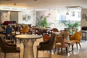 a restaurant with tables and chairs and a bar at The Aldott Cyber City in Gurgaon