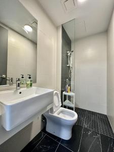 a white bathroom with a sink and a toilet at Beacon Executive Suites #Georgetown #InfinityPool #15 in George Town
