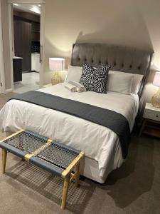 a bedroom with a large bed with a tray on it at Triology Menlyn Maine Residences in Pretoria