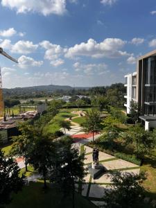 a view of a park with a building and a crane at Triology Menlyn Maine Residences in Pretoria