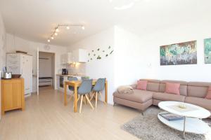 a living room with a couch and a table at Dünenblick Wohnung 07 in Boltenhagen