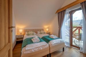 Postel nebo postele na pokoji v ubytování Apartamenty Otulina + 37 fotografií