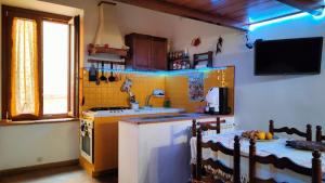 a kitchen with a table and a stove top oven at A BULLACCO With Parking in Gaeta