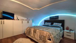 a bedroom with a bed with blue lights on the ceiling at A BULLACCO With Parking in Gaeta