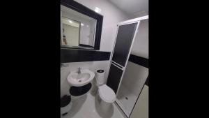 a bathroom with a sink and a toilet and a mirror at Bm-14G Charming Cartagena Lodge with Shared Pool and Private Terrace in Cartagena de Indias +7 photos