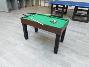 a green pool table with balls and cues on it at Bm-4 room near the sea with air conditioning and WIFI in Cartagena de Indias