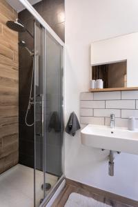 a bathroom with a sink and a shower at Authentic Maltese 2-bedroom House with Terrace in Żejtun