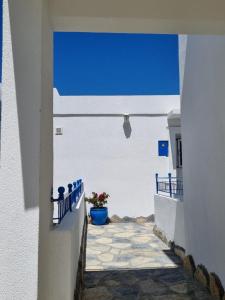 a narrow alley with white walls and a blue sky at Apartment Begonville in Bodrum City