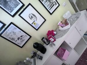 a room with a white cabinet and pictures on a wall at Casa Riri in San Benedetto del Tronto