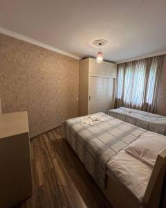 a hotel room with two beds and a window at Bethlehem Terrace in Tbilisi City