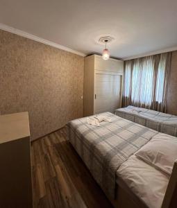 a hotel room with two beds and a window at Bethlehem Terrace in Tbilisi City