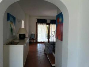 a living room with an archway leading to a living room at Villa Serena A in Stintino