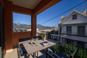 a balcony with a table and chairs and a view at Napier Maisonette in Argostoli