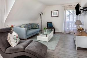 a living room with a couch and a table at Ferienwohnung Trixi in Sexau