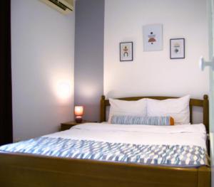 a bedroom with a bed with a blue wall at Yeshill Apart & Studio in Budva