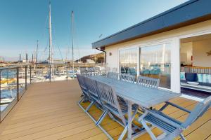 a wooden deck with a table and chairs on a boat at Crabbers' Wharf in Portland