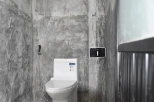 a bathroom with a white toilet in a wall at My Destiny in Ban Wang Muang (1)