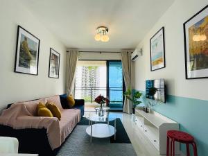 a living room with a couch and a table at Sea&CityView 2-bedroom Fully Furnished Apartment Forest City #freeWIFI in Gelang Patah