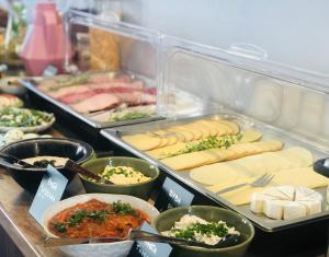 ein Buffet mit Käse und anderen Speisen in der Unterkunft Azalia in Ustronie Morskie