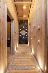 a hallway with wood paneling and a stone wall at Naturelife Bungalows & SPA in Cıralı