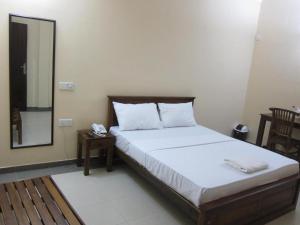 Postel nebo postele na pokoji v ubytování Hotel Oviya