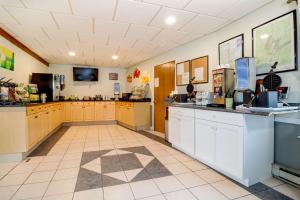 a large room with a kitchen with cabinets and a counter at Quality Inn & Suites in Lincoln