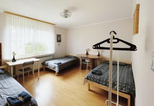 a room with two beds and a table and a window at Messezimmer Laatzen 30880 in Hannover