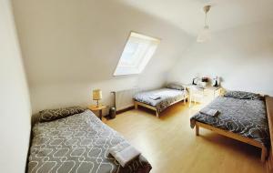 a bedroom with two beds and a table and a window at Messezimmer Laatzen 30880 in Hannover