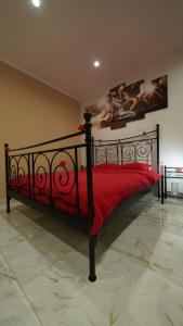 a bedroom with a bed with a red bedspread at Diamond Apartment Piran FREE PARKING in Piran