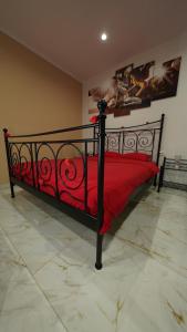 a black bed with a red bedspread in a room at Diamond Apartment Piran FREE PARKING in Piran