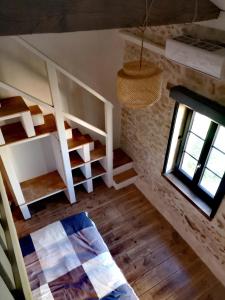 a living room with a staircase and a window at Les Trois Jolies 