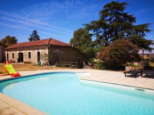 a large swimming pool in front of a house at Les Trois Jolies in Maylis