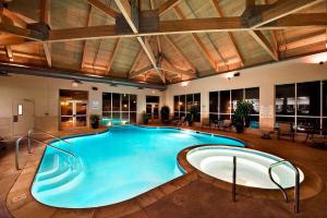a large swimming pool in a building with a ceiling at Cypress Bend Resort, a Wyndham Hotel in Many