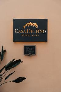 a sign for a casa delilus hotel and spa on a wall at Casa Delfino Hotel & Spa in Chania