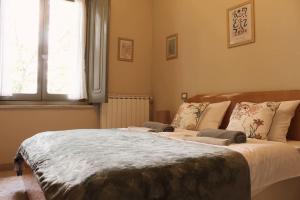 a bedroom with a large bed and a window at il nuvoloso in Città della Pieve