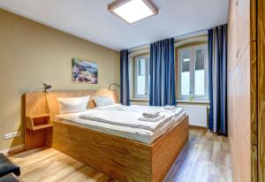 ein Schlafzimmer mit einem großen Holzbett vor einem Fenster in der Unterkunft Ferienwohnung Düne 25/1 in Zinnowitz