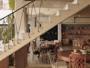 a room with a staircase and a table and chairs at Mona Athens in Athens