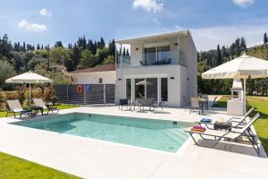 a villa with a swimming pool and a house at VILLA ELENA PRIVATE POOL Kontokali villas in Kontokali