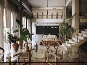 a living room with a table and some plants at Mona Athens in Athens