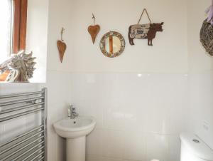 a bathroom with a toilet and a sink at Long House in Beaumaris +24 photos