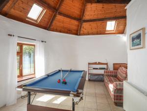 a living room with a pool table in it at Long House in Beaumaris