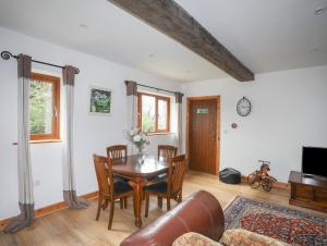 ein Wohnzimmer mit Tisch und Couch in der Unterkunft Long Cottage in Beaumaris