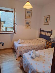 1 dormitorio con 2 camas y ventana en Apartamento Nevados 24321, en Anciles
