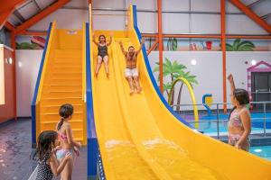 a group of people on a slide in a pool at Arizona - Pura Vida Holidays Caravan in Clacton-on-Sea
