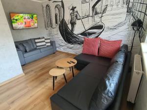 a living room with a couch and a hammock at JDK Apartamenty Legionów 32m2 4-osobowy in Kalisz